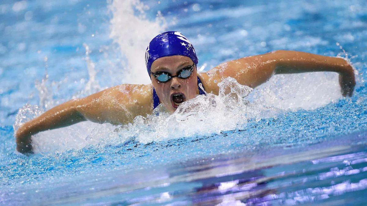 Female swimmer competing in breast stroke event