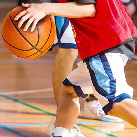 Young male dribbling a basketball