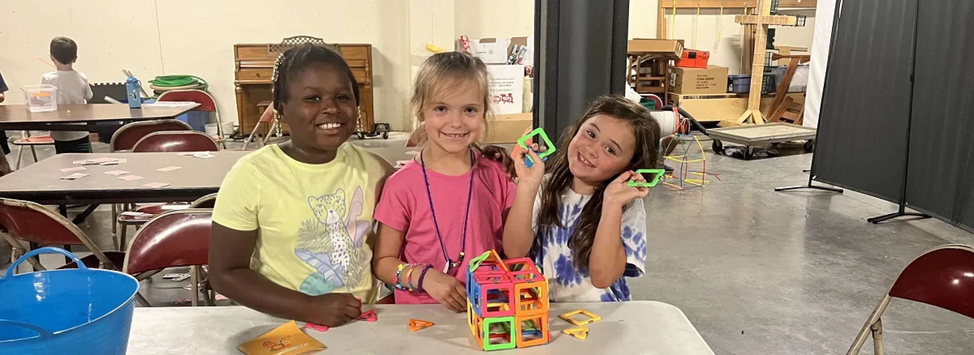 Three camp girls doing crafts